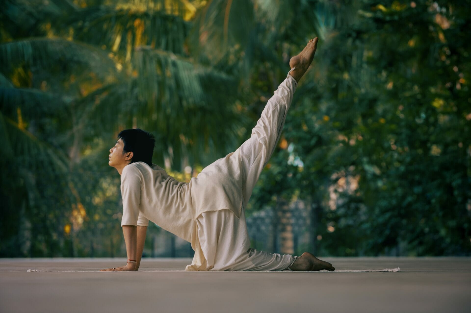 Uma mulher fazendo uma pose de yoga em frente a uma árvore no Brasil.