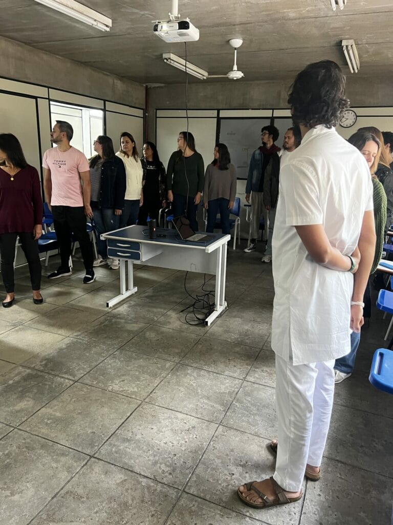 A group of people standing in a classroom.
