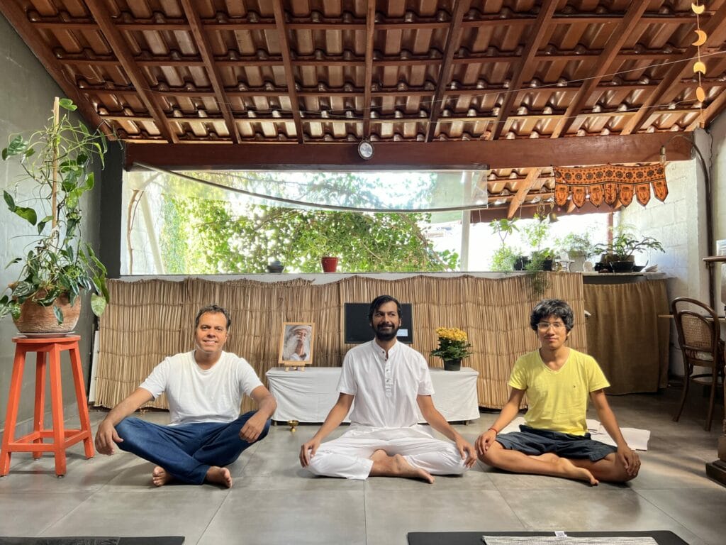 A group of people sitting in a room doing yoga.